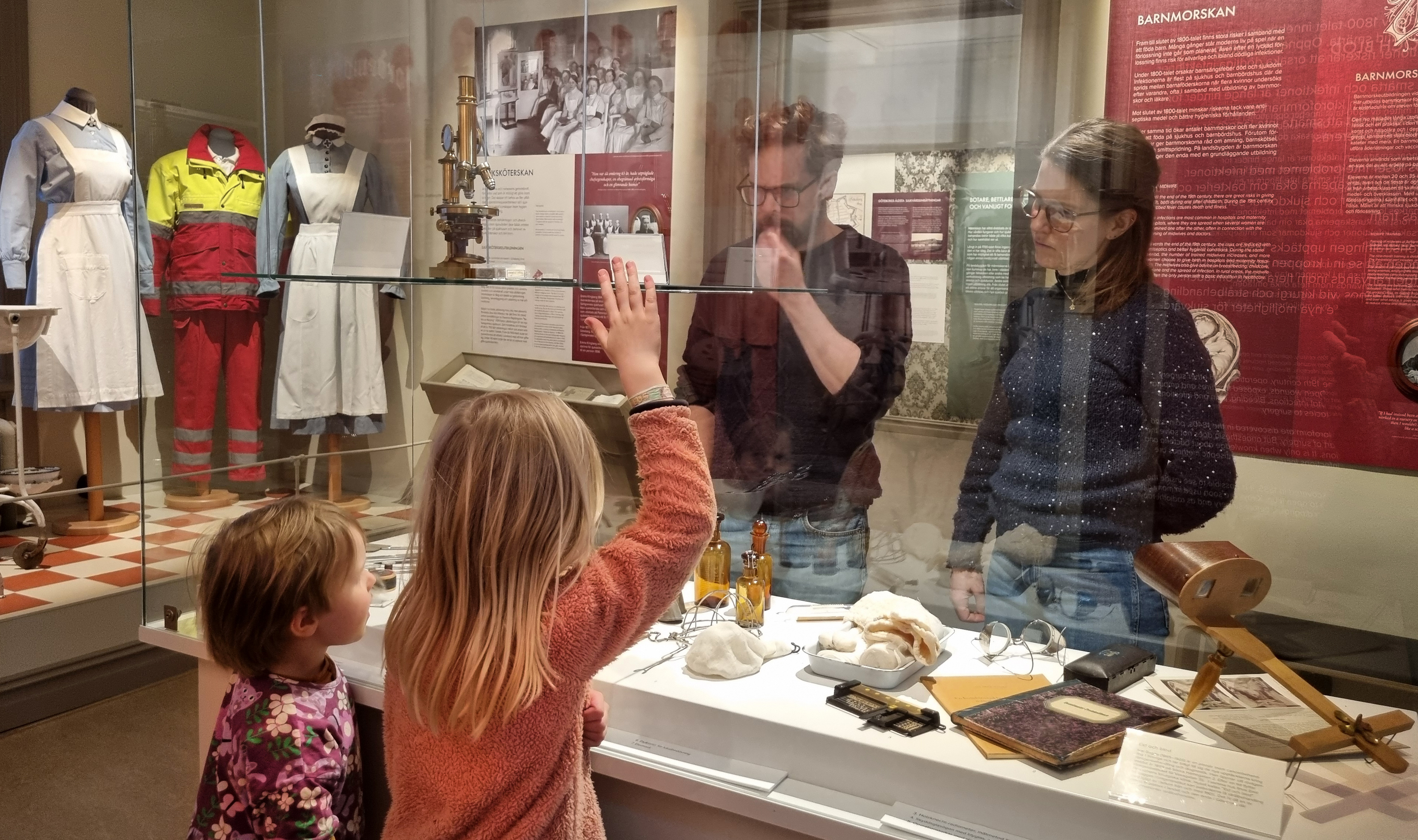 family watches a cabinett with equipment