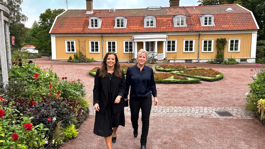 Två kvinnor går mot kameran. de ler.