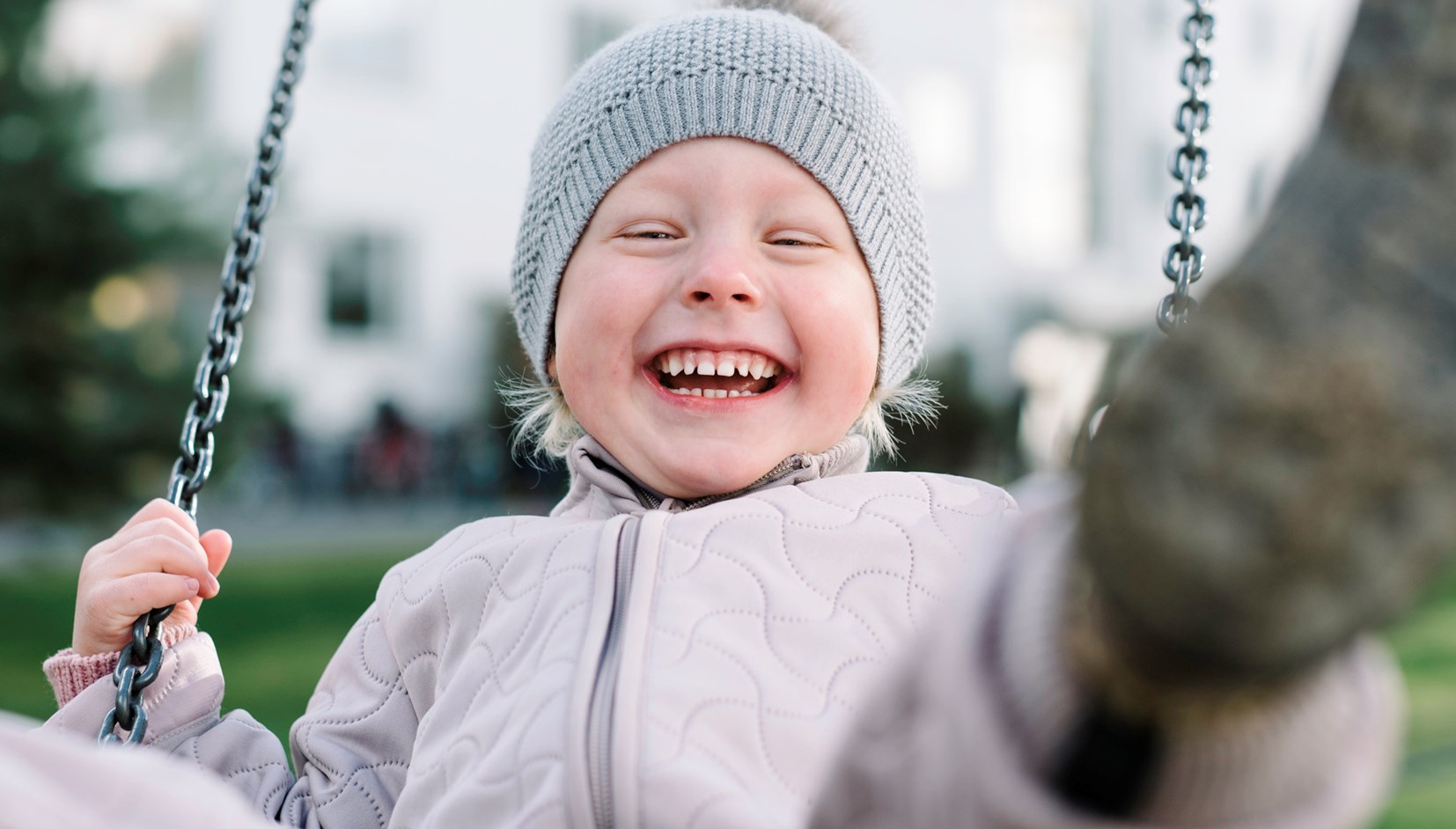 Boy having fun on swing in playground