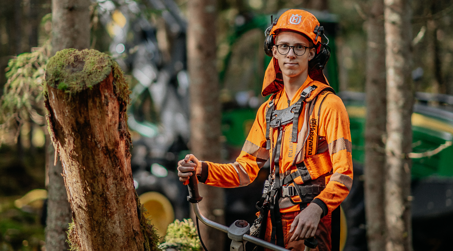 Student in high visibility clothing with working equipment