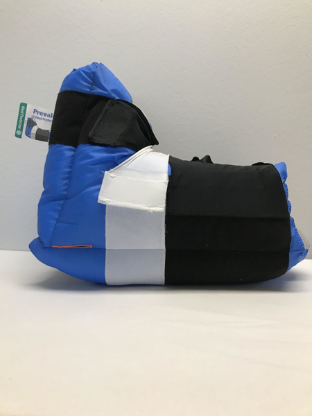 Blå hälkudde med svarta och vita kardborrband