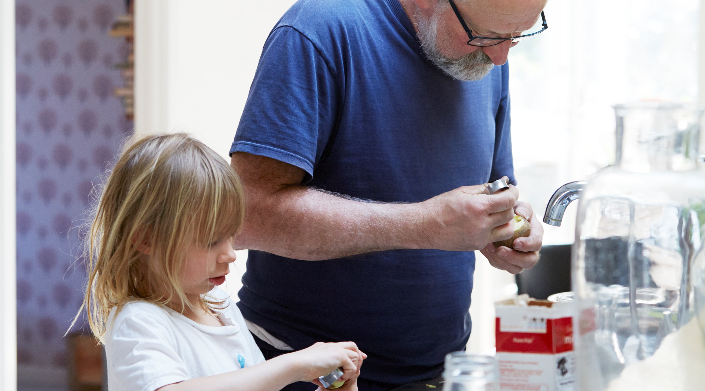 Man lagar mat med barn.