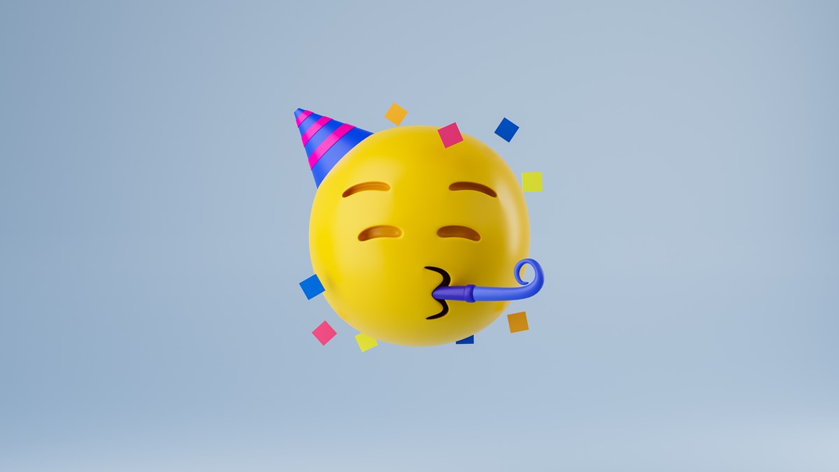 Gul emoji med partyhatt som blåser i en partytuta