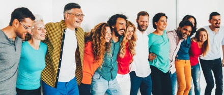 happy working team holding each other